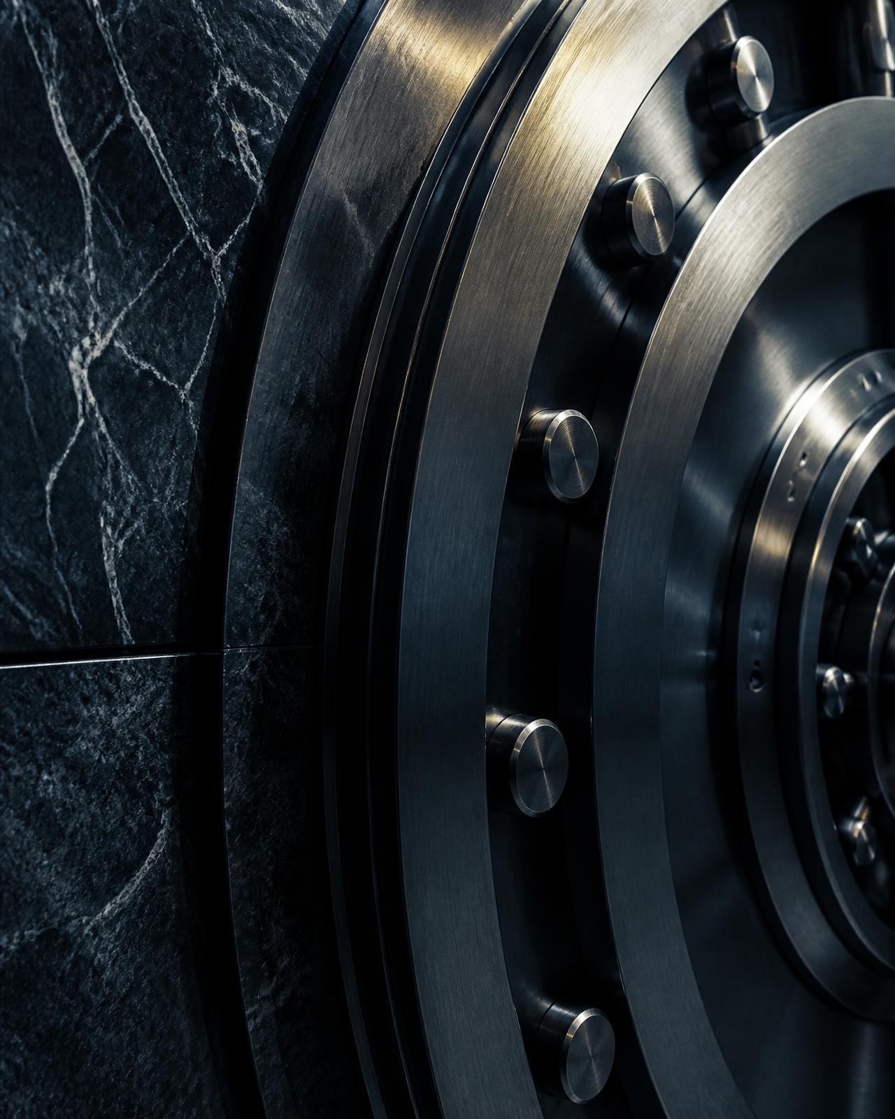 Detail of a Deutscorp Bank vault door in polished steel and stone